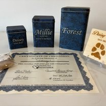 engraved metal urns in three sizes with a wooden paw print keepsake